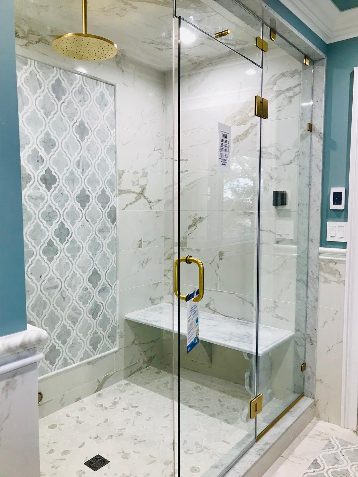Custom tiled shower with marble bench